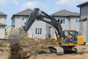 Basement excavation with a backhoe - careers in trenching & excavation with Superior Trenching LTD.